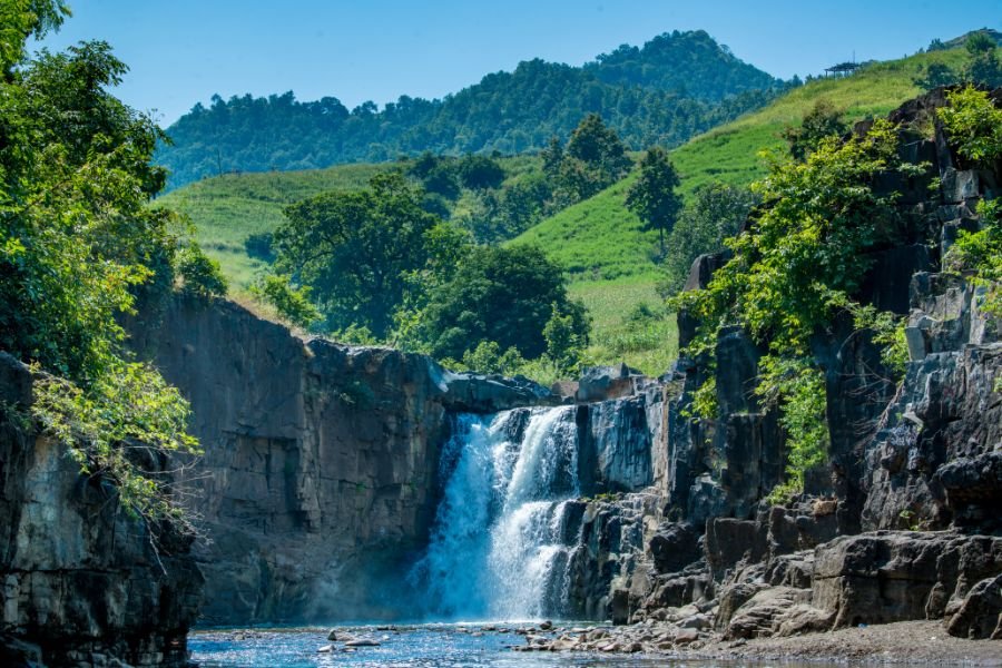Waterfall in a green valley near Kevadiya